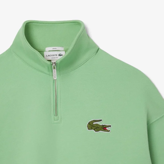 Unisex-Sweatshirt mit halbem Reißverschluss, lockerer Passform und Emblem-Akzent